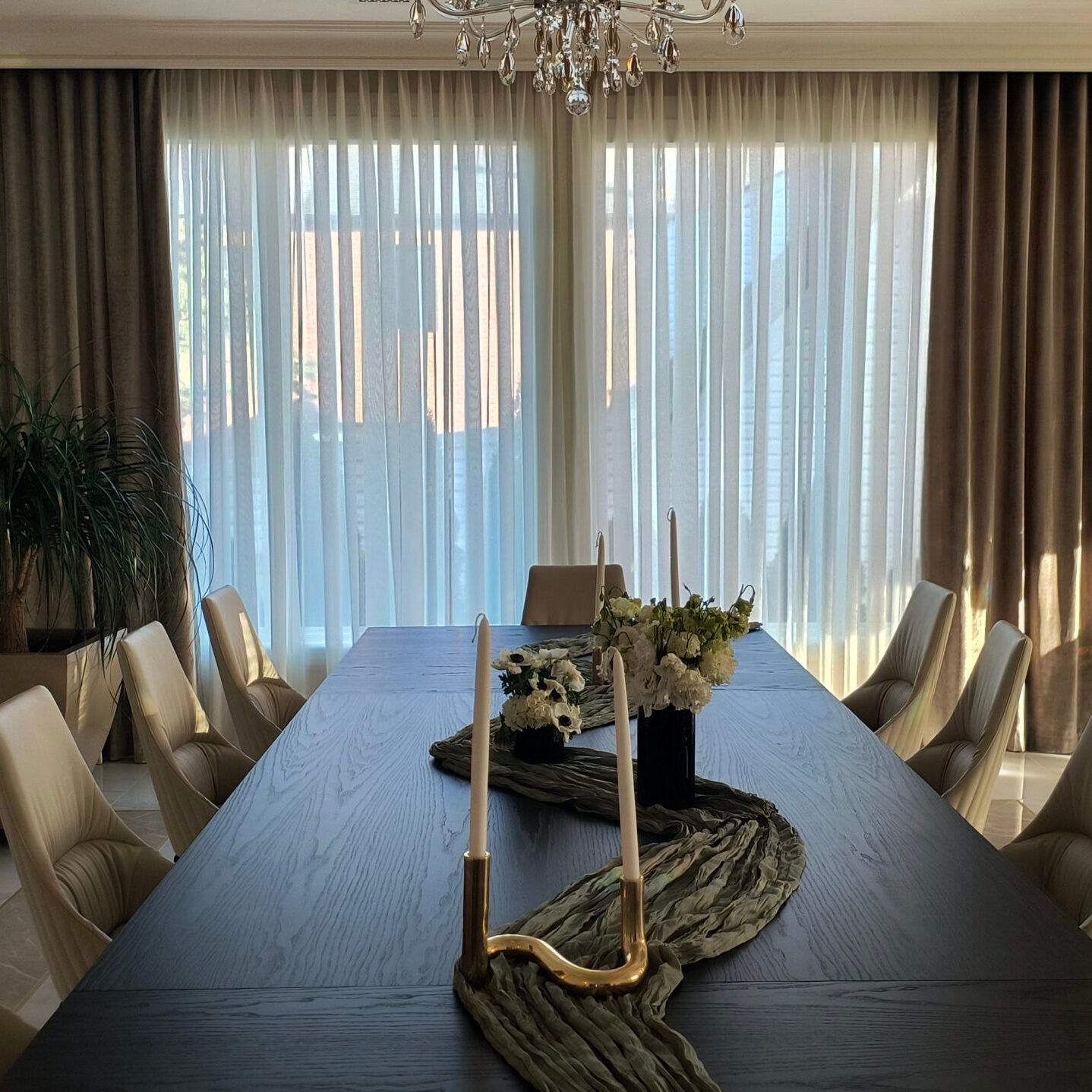 Modern dining room with elegant curtains installed on a dash track system