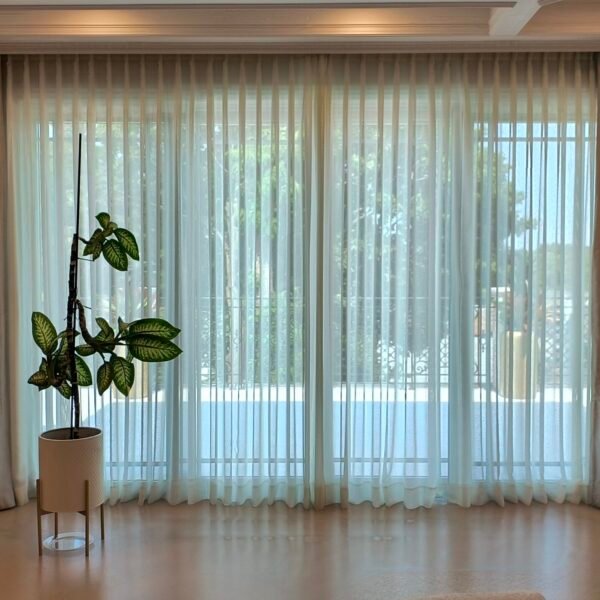 Elegant window with velvet and sheer curtains installed on a dash track system