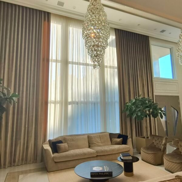 Luxury living room with tall layered drapery installed on a Euro Track system